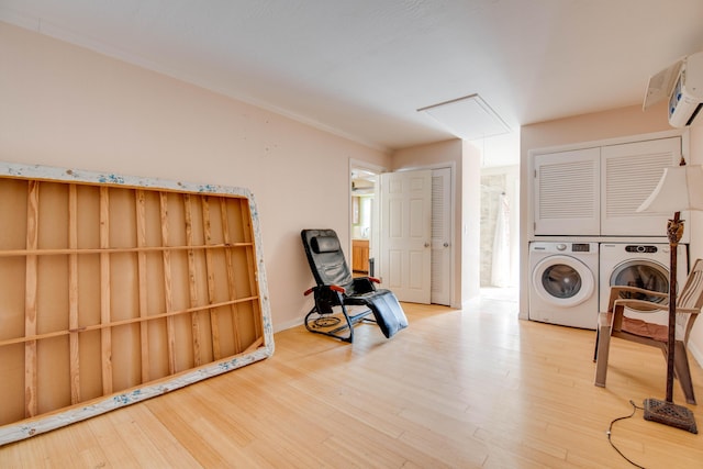 clothes washing area with laundry area, attic access, wood finished floors, crown molding, and separate washer and dryer