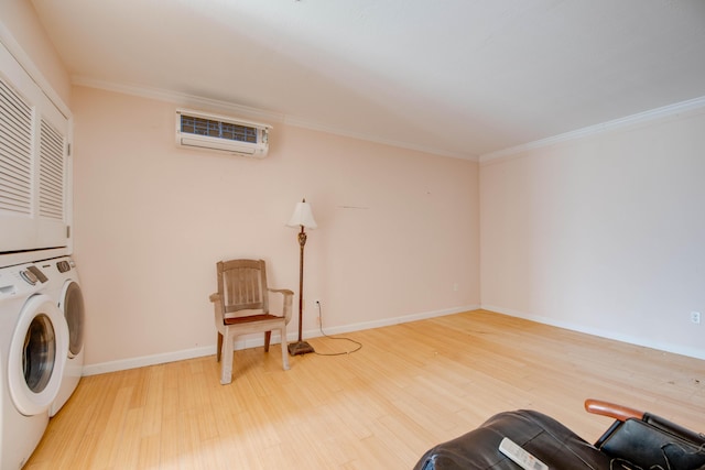 interior space featuring laundry area, wood finished floors, crown molding, an AC wall unit, and stacked washing maching and dryer