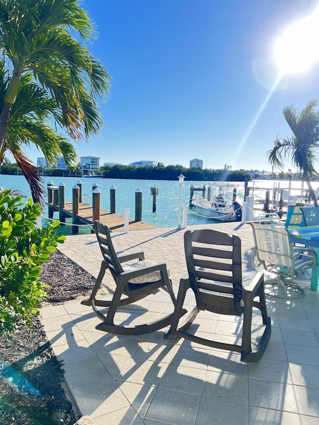 view of patio / terrace featuring a water view and a boat dock