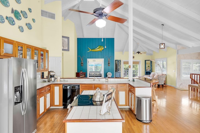 835 70th St, Gulf, Marathon, FL 33050 - kitchen featuring black appliances, ceiling fan, high vaulted ceiling, light wood-style flooring, and tile counters