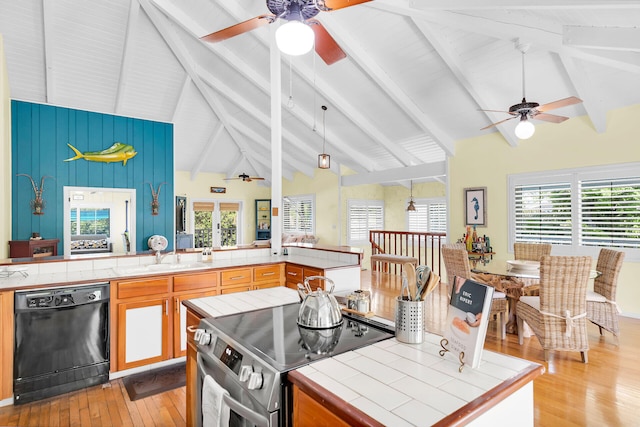 835 70th St, Gulf, Marathon, FL 33050 - kitchen featuring dishwasher, electric range, ceiling fan, tile counters, and light wood-type flooring