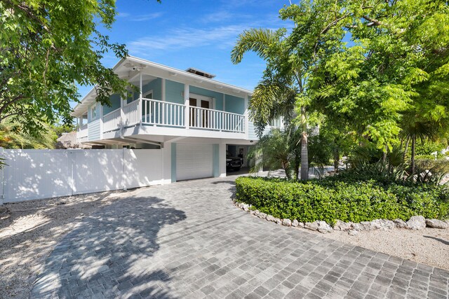 835 70th St, Gulf, Marathon, FL 33050 - view of front of home featuring a balcony, a garage, and decorative driveway