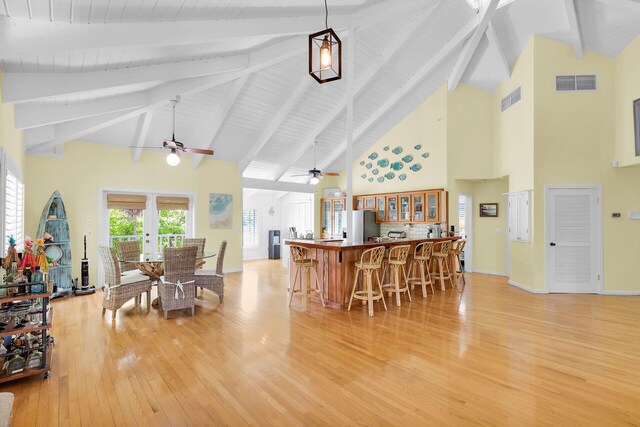 835 70th St, Gulf, Marathon, FL 33050 - kitchen featuring high vaulted ceiling, freestanding refrigerator, a ceiling fan, light wood-style floors, and a kitchen bar