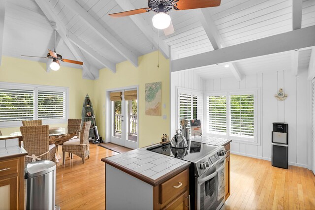 835 70th St, Gulf, Marathon, FL 33050 - kitchen with stainless steel range with electric stovetop, tile countertops, a ceiling fan, light wood finished floors, and wooden ceiling