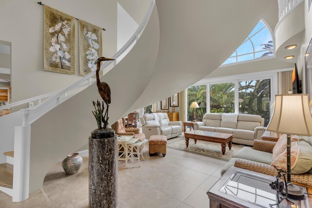 210 14th St, Key Colony, FL 33051 - living room with stairway, a high ceiling, and light tile patterned floors