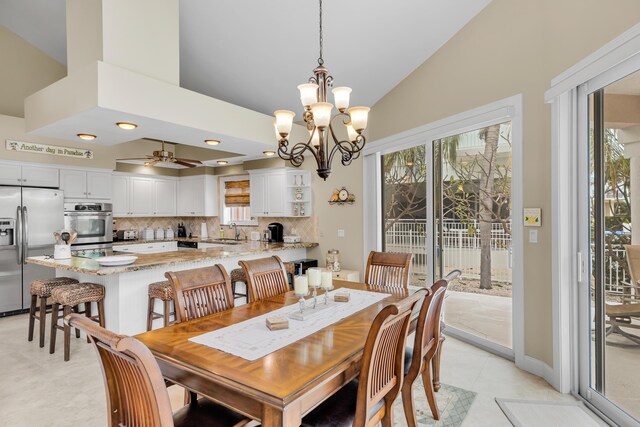 210 14th St, Key Colony, FL 33051 - dining room with high vaulted ceiling, light tile patterned floors, and ceiling fan with notable chandelier