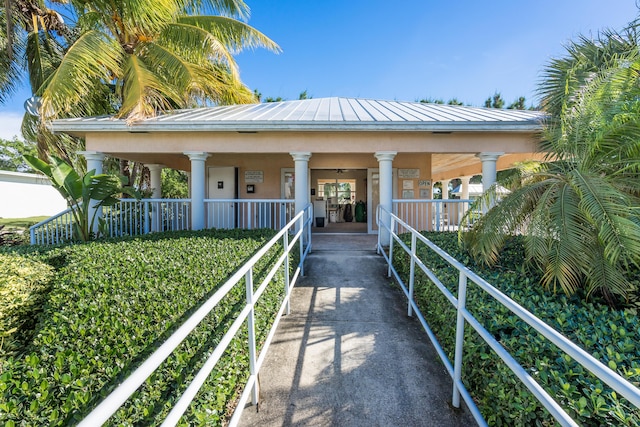 210 14th St, Key Colony, FL 33051 - view of front of house featuring a standing seam roof, covered porch, metal roof, and stucco siding