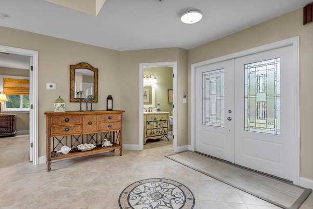 210 14th St, Key Colony, FL 33051 - entryway with french doors, light tile patterned flooring, and baseboards