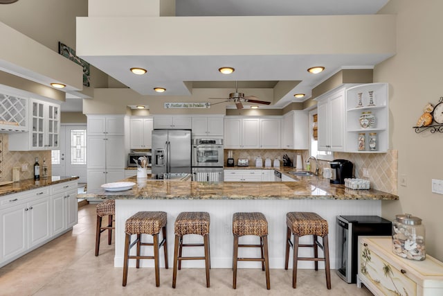 210 14th St, Key Colony, FL 33051 - kitchen featuring a peninsula, decorative backsplash, stainless steel appliances, and a sink