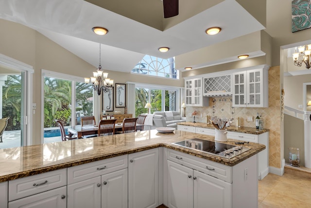 210 14th St, Key Colony, FL 33051 - kitchen featuring lofted ceiling, an inviting chandelier, and black electric stovetop