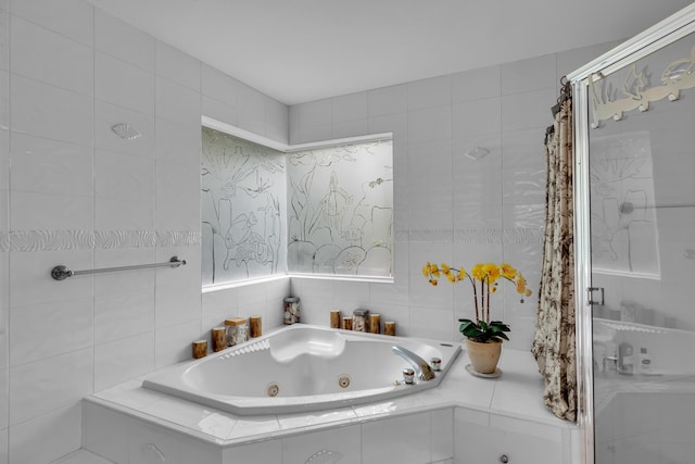 210 14th St, Key Colony, FL 33051 - bathroom featuring a whirlpool tub, a stall shower, and tile walls