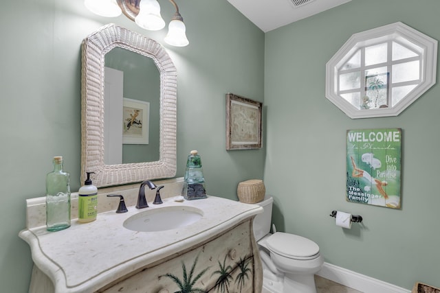 210 14th St, Key Colony, FL 33051 - bathroom featuring a notable chandelier, visible vents, toilet, vanity, and baseboards