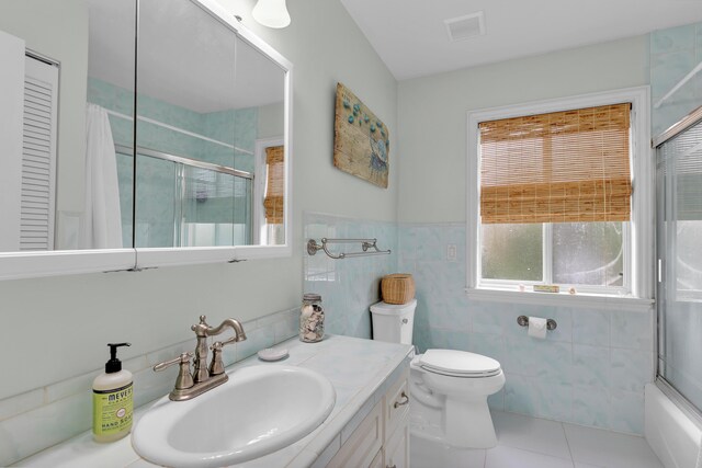 210 14th St, Key Colony, FL 33051 - bathroom with visible vents, toilet, tile patterned flooring, vanity, and tile walls