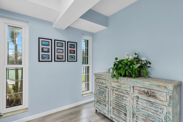 hallway with light wood-style floors and baseboards