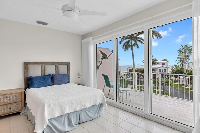 bedroom with ceiling fan, light tile patterned floors, visible vents, and access to exterior