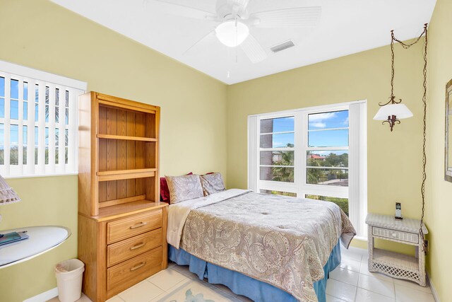 bedroom with visible vents, a ceiling fan, and light tile patterned flooring