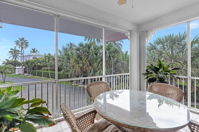 sunroom / solarium with a wealth of natural light and a ceiling fan