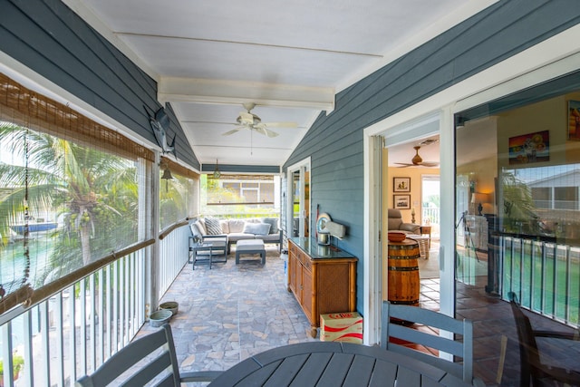 wooden terrace with an outdoor living space and a ceiling fan