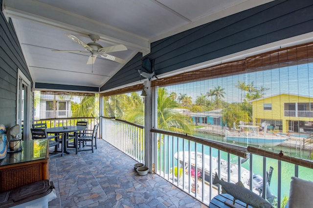 view of patio featuring a ceiling fan and a balcony