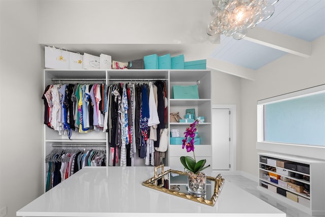 walk in closet featuring beamed ceiling