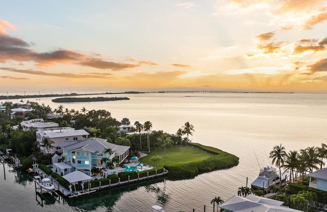 aerial view at dusk with a water view