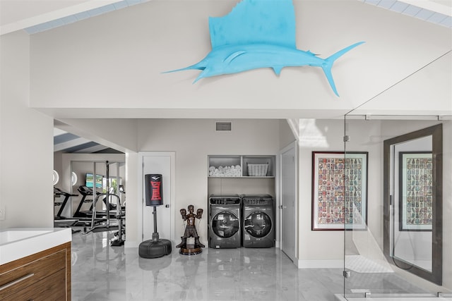 interior space with marble finish floor, visible vents, independent washer and dryer, and a high ceiling