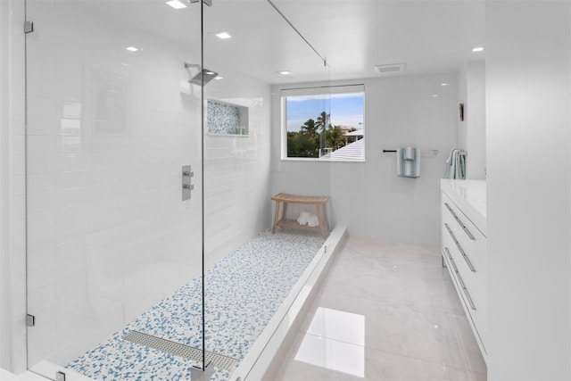 bathroom with visible vents, a stall shower, and vanity