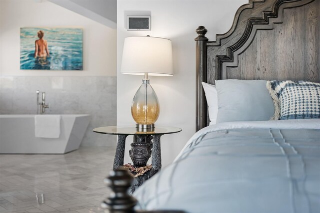 bedroom with a wainscoted wall and tile walls