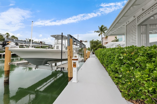 dock area with a water view and boat lift