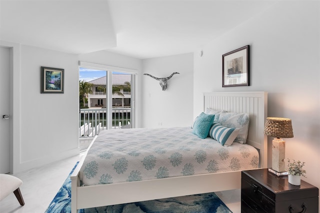 bedroom featuring access to exterior and light tile patterned floors