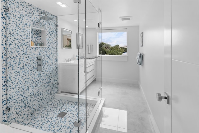 full bath featuring visible vents, a shower stall, vanity, and baseboards