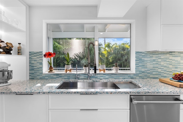 kitchen with white cabinets, dishwasher, and a sink