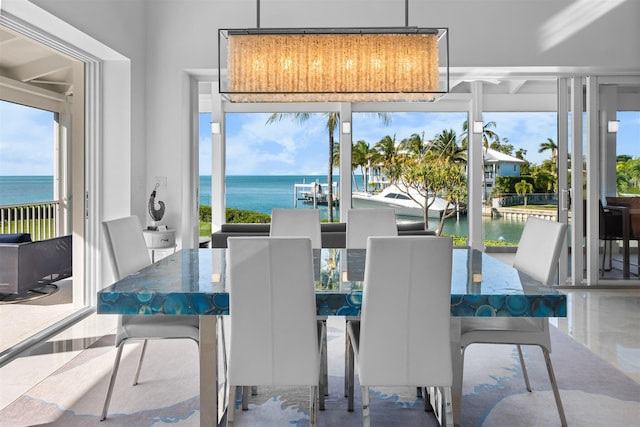 dining room featuring plenty of natural light and a water view