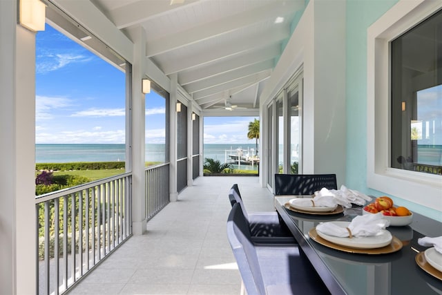 balcony featuring a water view and ceiling fan