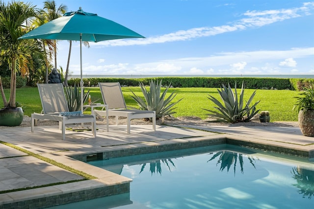 pool with a yard, a rural view, and a patio