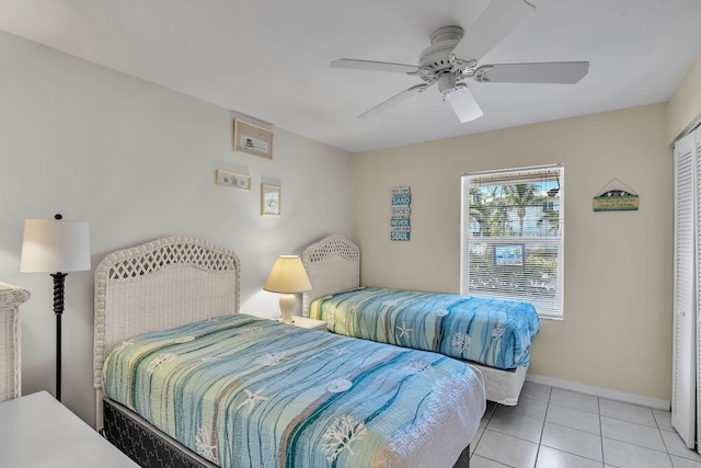 bedroom with a ceiling fan, baseboards, and light tile patterned floors