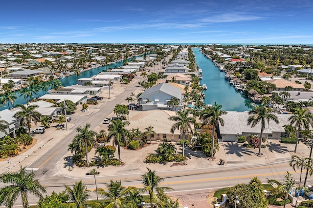 birds eye view of property featuring a water view and a residential view