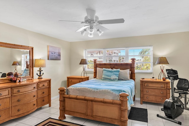 bedroom featuring ceiling fan, baseboards, and light tile patterned flooring