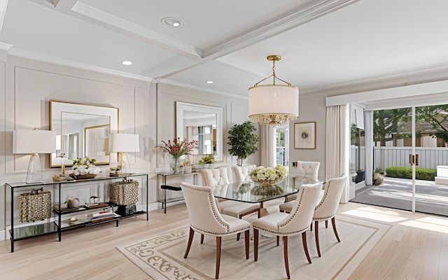 dining area featuring ornamental molding, light wood-type flooring, a decorative wall, and recessed lighting