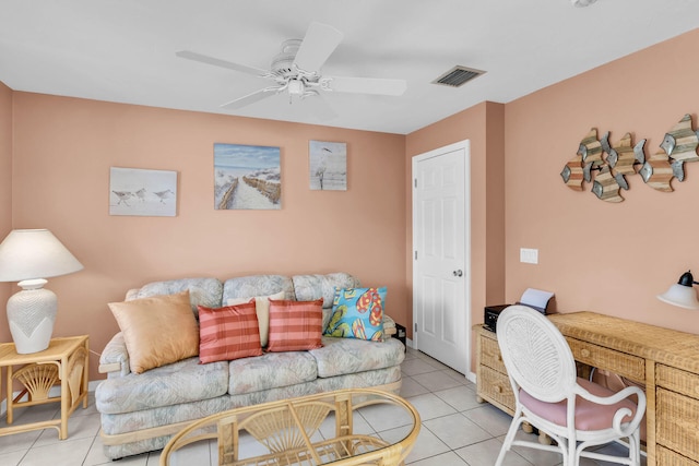 living room featuring a ceiling fan, visible vents, and light tile patterned floors