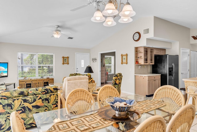 dining space featuring vaulted ceiling, ceiling fan, visible vents, and a healthy amount of sunlight