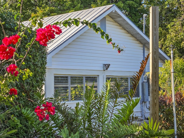 view of property exterior featuring a standing seam roof and metal roof