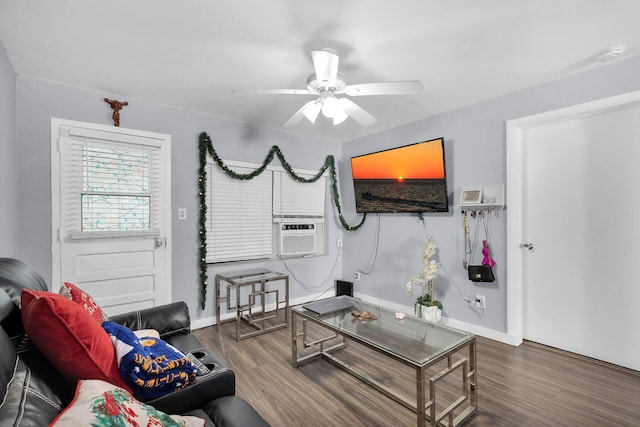 living area with cooling unit, wood finished floors, a ceiling fan, and baseboards