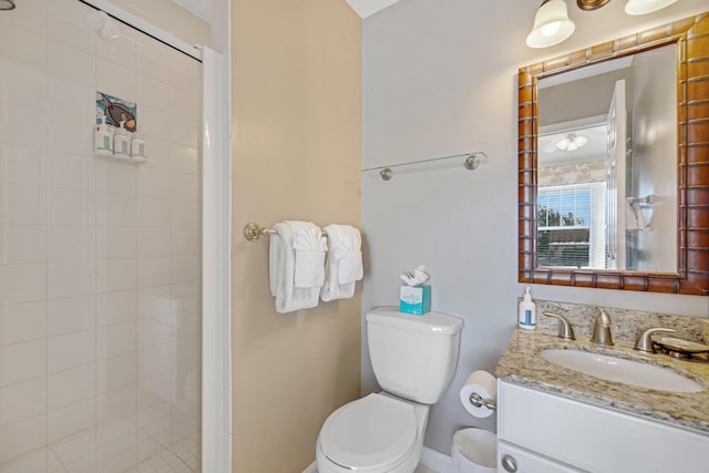 full bathroom with a stall shower, vanity, and toilet