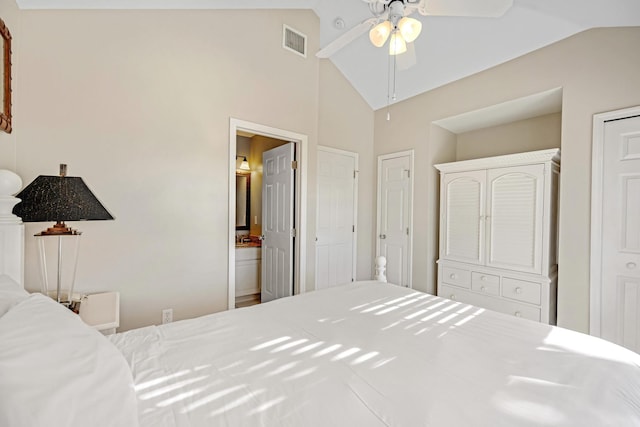 bedroom with lofted ceiling, ensuite bath, visible vents, and a ceiling fan