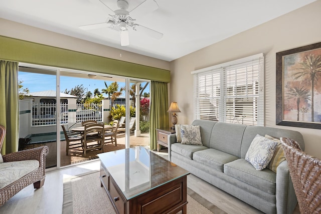 living area with ceiling fan and light wood-style flooring