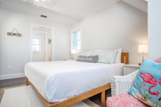 bedroom with wood finished floors, visible vents, ceiling fan, and baseboards