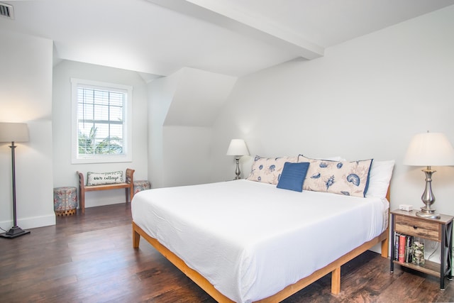 bedroom featuring wood finished floors, visible vents, lofted ceiling with beams, and baseboards