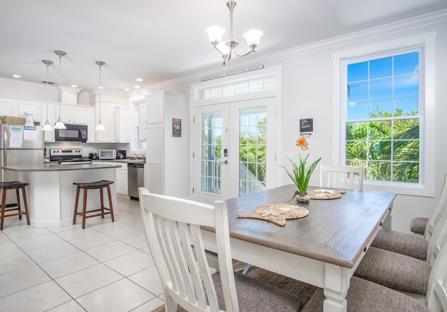 dining space featuring light tile patterned floors, a toaster, recessed lighting, ornamental molding, and a notable chandelier