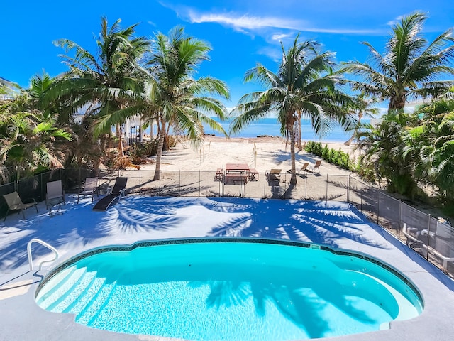 view of swimming pool with fence, a swimming pool, and a patio area